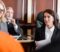 blonde advocate smiling near prosecutor and senior judge on background