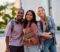 Multiracial group of happy college friends outdoors looking at camera.
