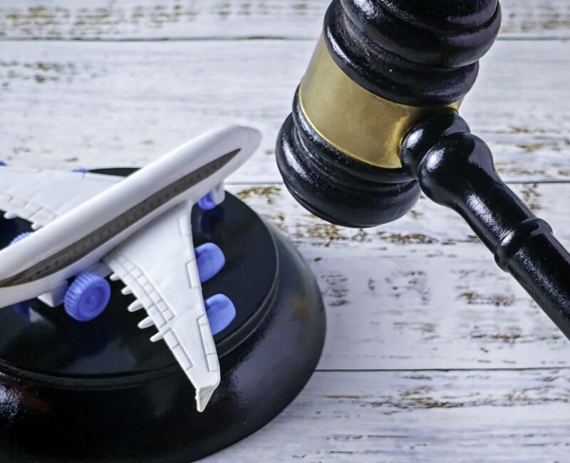 Aviation Legal Regulation: Judge's Gavel Hovering Over Miniature Airplane Model